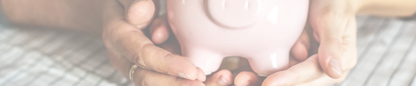 Hand holding a piggy bank